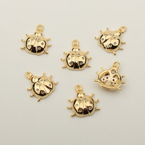 May include: Six gold-tone ladybug charms with clear rhinestone accents. Each charm has a loop for attaching to jewelry or other crafts.