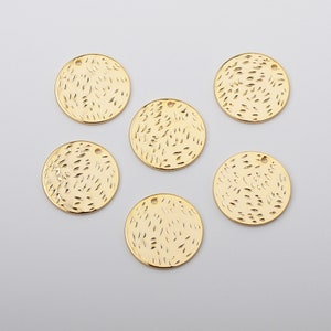 Könnte beinhalten: Sechs runde Anhänger aus goldfarbenem Metall mit strukturierter Oberfläche. Jeder Anhänger hat oben ein kleines Loch zum Anbringen an einer Halskette oder einem Armband.