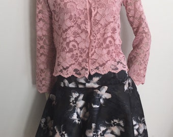 Tea Rose and Grey Ensemble. Women's Blush Pink Turtle Neck Top with Cap Sleeves, Lace Jacket, and Grey Jacquard Floral Skirt.
