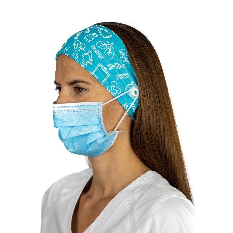 May include: A turquoise headband with a white print of medical symbols and the text "Healthcare Heroes". The headband has a button on the side to hold a face mask.