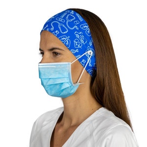 May include: A blue headband with a white print of medical symbols and the text "Healthcare Heroes". The headband has a button on the side to hold a face mask.