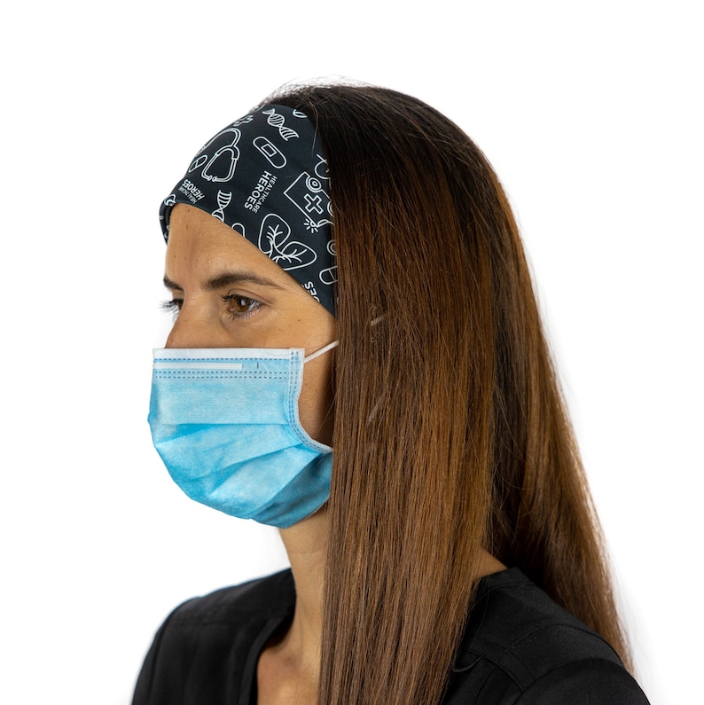 May include: A person wearing a black headband with a white design featuring medical symbols and the text "Healthcare Heroes". They are also wearing a light blue surgical mask.