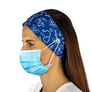 May include: A blue headband with a white print of medical symbols, including a stethoscope, a cross, a heart, and a pill bottle. The headband has a button on the side to hold a face mask in place. The headband is worn by a person with long brown hair.