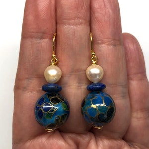 May include: Gold earrings with a blue and white cloisonn&eacute; bead and a white pearl bead.