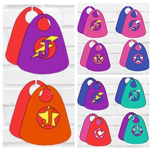 May include: Set of eight superhero capes in different colours and letters. The capes are red, orange, purple, pink, blue, and green. Each cape has a letter on the front, including J, K, A, N, and C.
