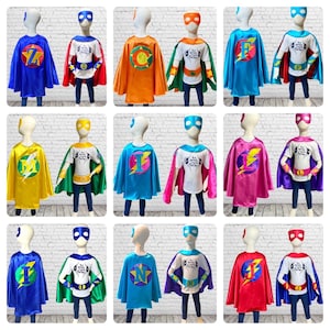 May include: Nine sets of superhero costumes for kids, each set includes a cape, a t-shirt, and a mask. The capes are in various colors, including blue, yellow, orange, pink, and red. The t-shirts are white with a graphic of a lightning bolt and the text "I'm Super" on them. The masks are blue and have a yellow lightning bolt design.