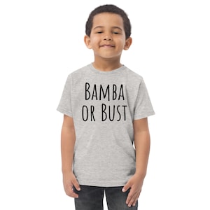May include: A light gray youth t-shirt with the words "BAMBA OR BUST" printed in black. The shirt is made of a soft material and is suitable for everyday wear. The shirt is being worn by a young child.