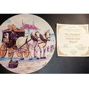 May include: A white porcelain plate with a colorful painting of a horse-drawn carriage with two white horses pulling it. The carriage is carrying a driver and a passenger. The scene is set in a town with buildings in the background. The plate is part of a collection called "To Market" Working Horses. The plate is numbered 0916.