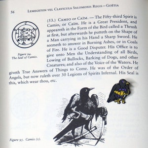 May include: A black and white illustration of a bird holding a sword. The bird is standing on a book with the text "Figure 95. Camio (1)." The text "(53.) CAMIO or CA&Iuml;M. - The Fifty-third Spirit is Camio, or Ca&iuml;m. He is a Great President, and appeareth in the Form of the Bird called a Thrush at first, but afterwards he putteth on the Shape of a Man carrying in his Hand a Sharp Sword. He seemeth to answer in Burning Ashes, or in Coals of Fire. He is a Good Disputer. His Office is to give unto Men the Understanding of all Birds, Lowing of Bullocks, Barking of Dogs, and other Creatures; and also of the Voice of the Waters. He giveth True Answers of Things to Come. He was of the Order of Angels, but now ruleth over 30 Legions of Spirits Infernal. His Seal is this, which wear thou, etc." is also visible.