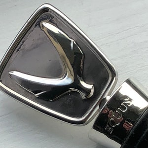 May include: Silver bottle stopper with a stylized bird design and the word "Equus" engraved on the side.