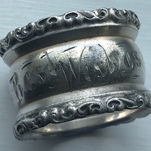 May include: Silver napkin ring with an ornate design and the inscription "The Walters" on the side.
