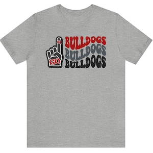 May include: A gray t-shirt with a red, black, and gray graphic of a raised hand with the number "#1" on the index finger and the words "GO BULLDOGS" repeated three times.