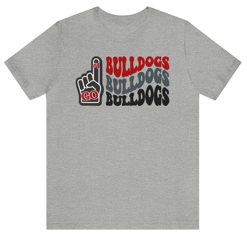 May include: A gray t-shirt with a red, black, and gray graphic of a raised hand with the number "#1" on the index finger and the words "GO BULLDOGS" repeated three times.