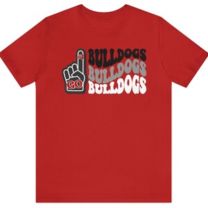 May include: Red t-shirt with a black and white graphic of a raised index finger with the words "GO BULLDOGS" repeated three times.