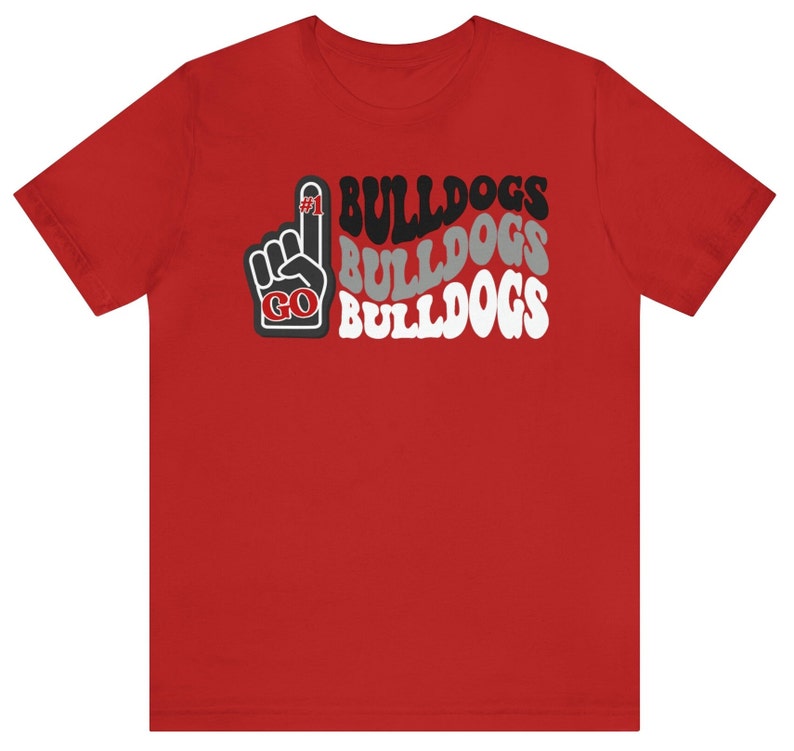 May include: Red t-shirt with a black and white graphic of a raised index finger with the words "GO BULLDOGS" repeated three times.