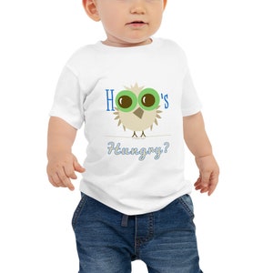 May include: White baby t-shirt with a cartoon owl graphic. The owl has large green eyes and is perched on a line. The text "Hoo's Hungry?" is printed in blue.