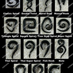 May include: A collection of 12 different black glass spiral ear plugs, each with a unique design. The ear plugs are displayed on a white background.