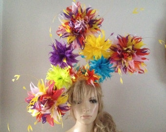 Multi coloured fascinator headpiece of yellow turquoise red orange black purple pink hand cut feather flowers.