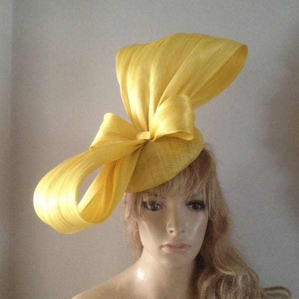 Yellow sinamay perching beret hat adorned with a magnificent hand sculptured silk abaca bow.