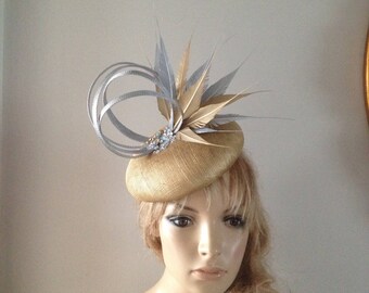 gold sinamay perching beret hat adorned with sculptured silver loops,hand cut gold & silver feathers.