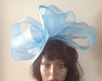 Pale blue sinamay twisting sculpture with headband attachment.