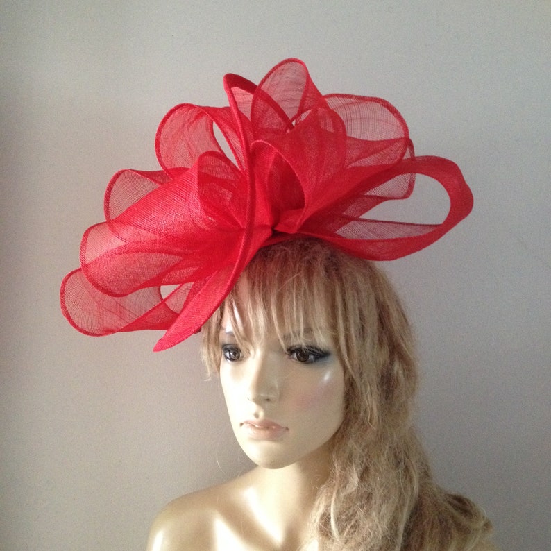 Red sinamay twisting fascinator sculpture with headband attachment. image 1