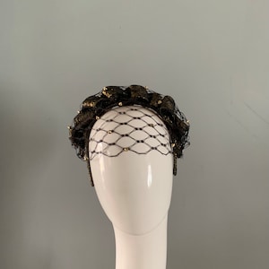 Black and Gold headband / fascinator adorned with vintage honeycomb veiling & gold metal studs.