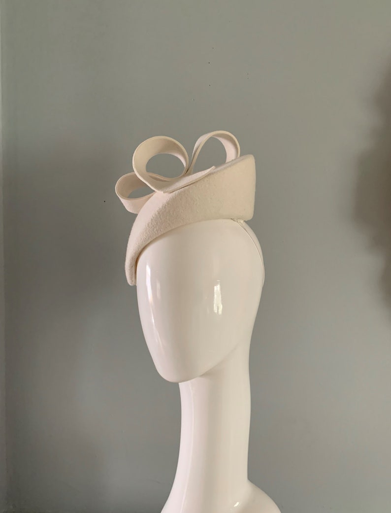 ivory wool felt perching beret hat adorned with a sculptured bow detail. image 6