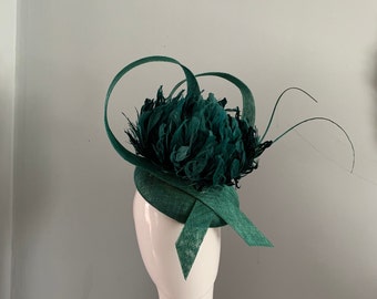 Teal Green perching beret hat adorned with a magnificent hand cut feather flower & a brace of curled quills.