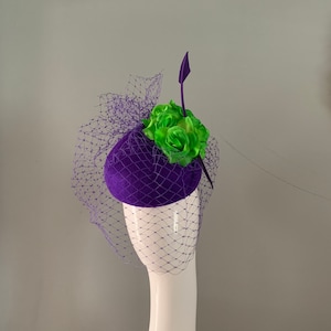 vintage teardrop purple wool felt hat embellished with lime silk flowers birdcage veiling pierced with a dramatic arrowhead feather detail