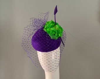 vintage teardrop purple wool felt hat embellished with lime silk flowers birdcage veiling pierced with a dramatic arrowhead feather detail