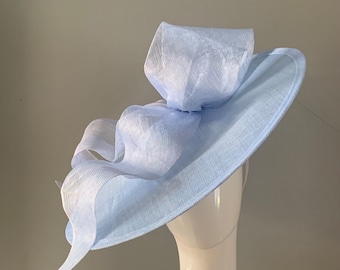 Large Pale Blue  saucer hat / fascinator adorned with a sculptured bow with headband attachment.