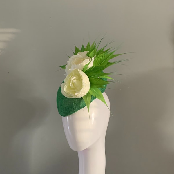 Emerald Green perching beret adorned with cream silken flowers and hand cut feather details.