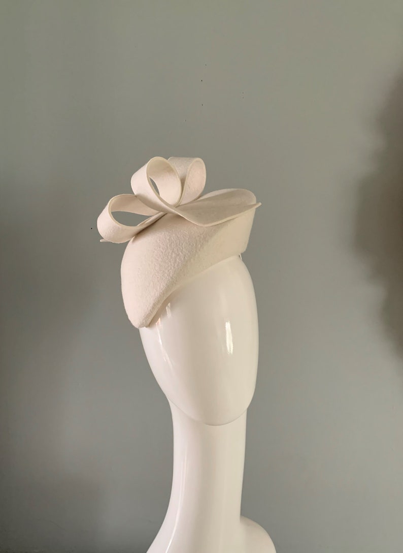 ivory wool felt perching beret hat adorned with a sculptured bow detail. image 4