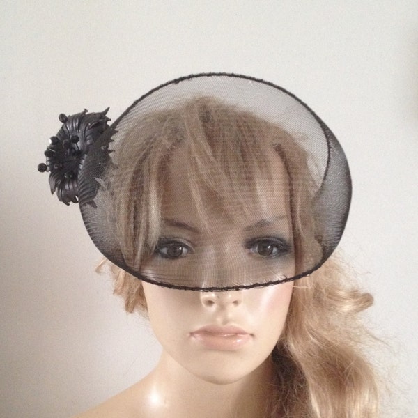 Dramatic sheer black crin veiled headpiece adorned with sculptured black leather flower & swarovski stamen details.