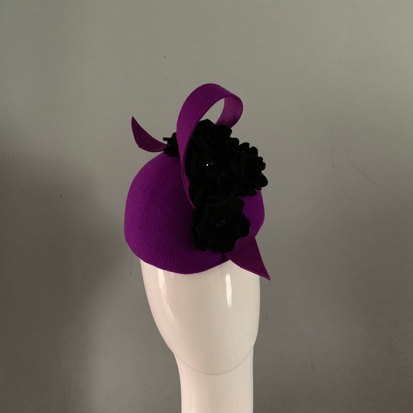 purple wool felt perching beret hat adorned with black sculptured felt roses centred with sparkling swarovski crystals.