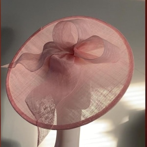 Large Pale Pink saucer hat / fascinator adorned with a sculptured bow with headband attachment.