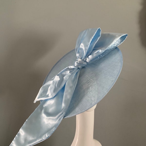 Large Pale Blue  saucer hat / fascinator adorned with an oversized sculptured satin bow with headband attachment.