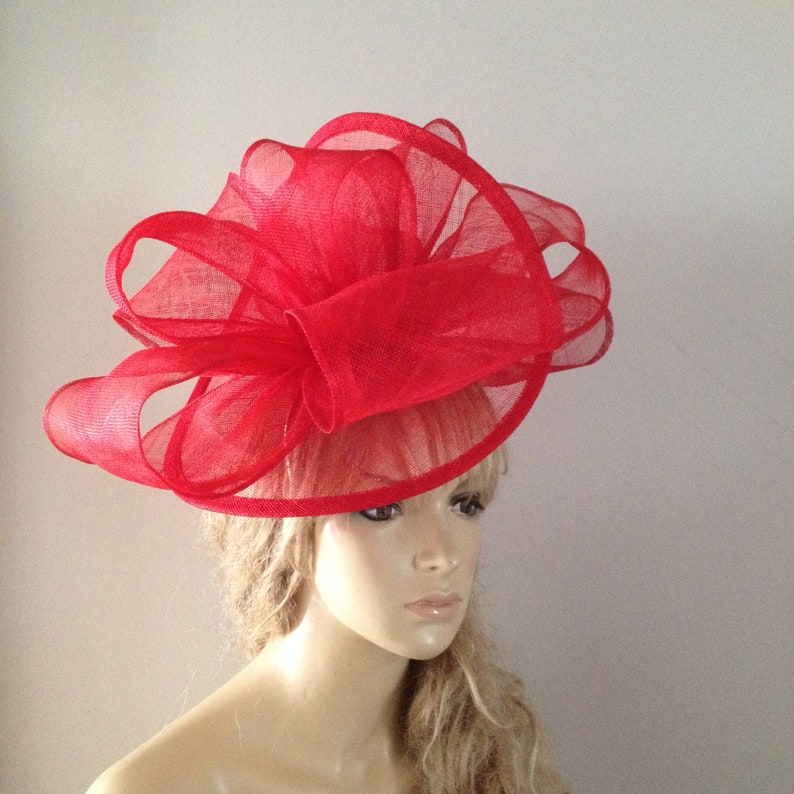 Red sinamay twisting fascinator sculpture with headband attachment. image 2