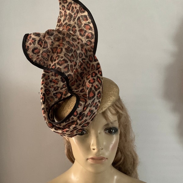 Gold perching beret hat adorned with a leopard print sinamay sculpture.