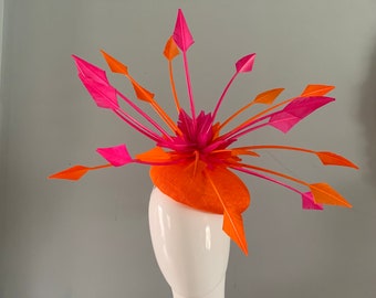 Orange perching beret hat adorned with a halo of dramatic Orange and Fuchsia arrow head feather details.