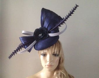 Navy perching beret hat adorned with silk abaca bow,hand cut feather details silver loops and silken flowers