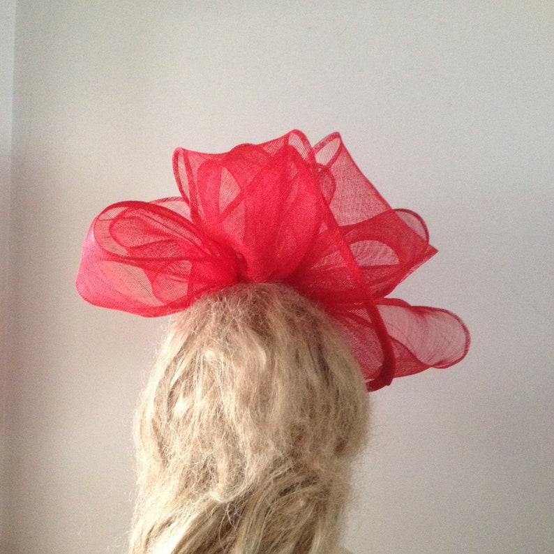 Red sinamay twisting fascinator sculpture with headband attachment. image 3