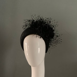 Black sinamay crown headpiece adorned with Merry Widow details and silken flowers.