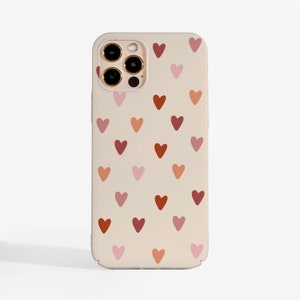 May include: A beige phone case with a pattern of small hearts in shades of pink, red, and orange. The case has a camera cutout and buttons. The overall design is simple and modern.