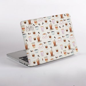 May include: A laptop skin featuring a repeating watercolor pattern of various coffee cups, mugs, and scattered coffee beans on a white background. The text "But first... COFFEE" is printed in a dark script font on the upper left side of the cover.