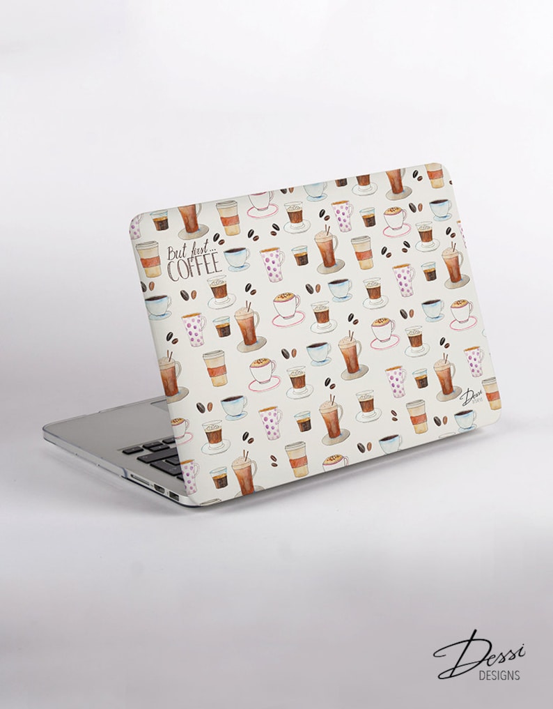 May include: A laptop skin featuring a repeating watercolor pattern of various coffee cups, mugs, and scattered coffee beans on a white background. The text "But first... COFFEE" is printed in a dark script font on the upper left side of the cover.