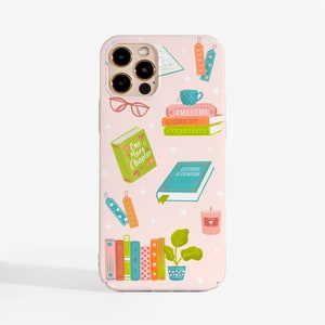 May include: A light pink phone case featuring a pattern of books, bookmarks, eyeglasses, a teacup, a candle, and a potted plant. The books include text reading One More Chapter, Awesome, Great, Fantastic, and Certified Bookworm, with small white flowers.