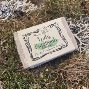 May include: A bar of soap with a brown label that reads "Madame Phoenix's Truly Patchouli Spell Soap" and "Proudly Handmade in Canada".