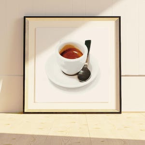 May include: A framed print featuring a white espresso cup filled with dark coffee, resting on a white saucer with a small spoon. The artwork is set against a neutral background, creating a minimalist aesthetic.